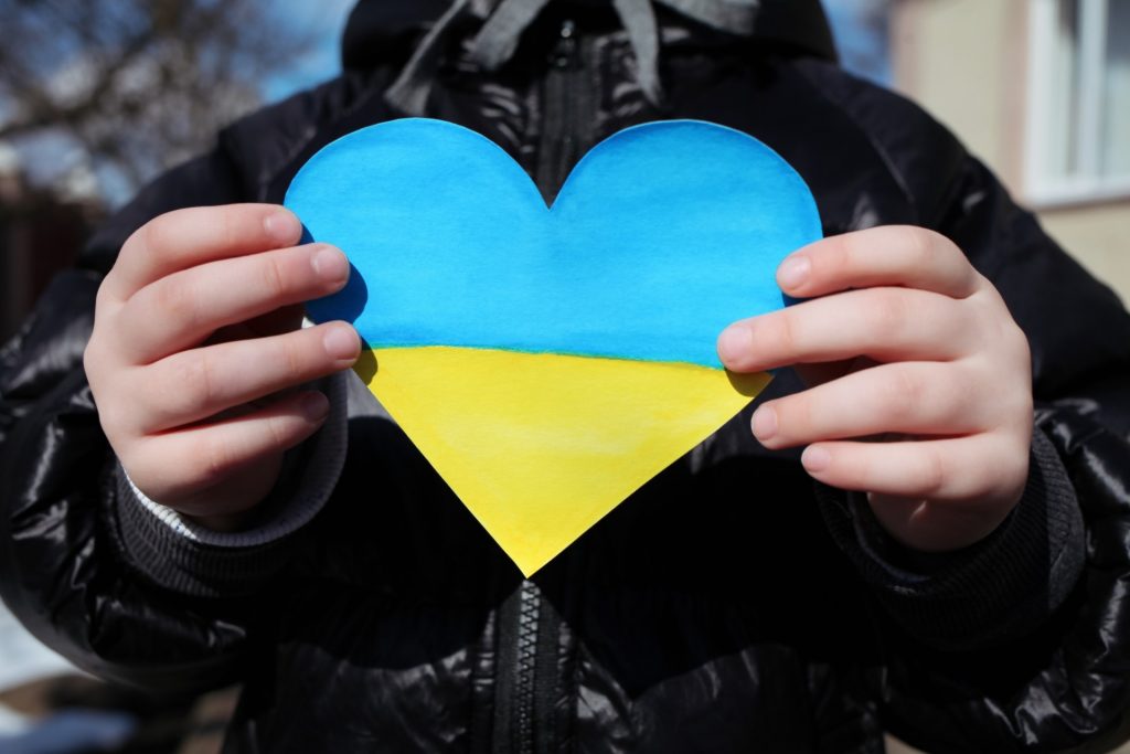 Heart in Ukrainian colors held by a person